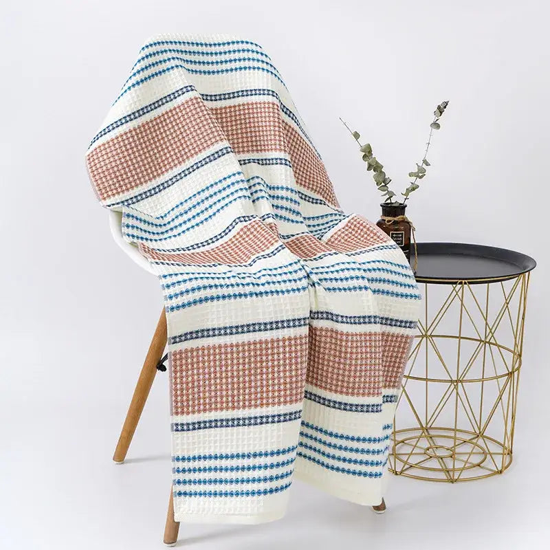 A decorbites cotton bath towel with embroidered honeycomb linen texture in white and blue with a cozy throw blanket pattern