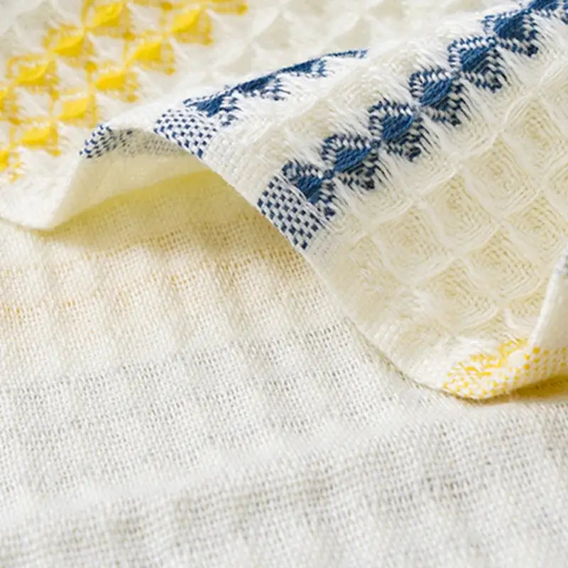 Embroidered white and blue cotton bath towel with intricate yellow patterns ideal for bathroom decorbites cotton bath use