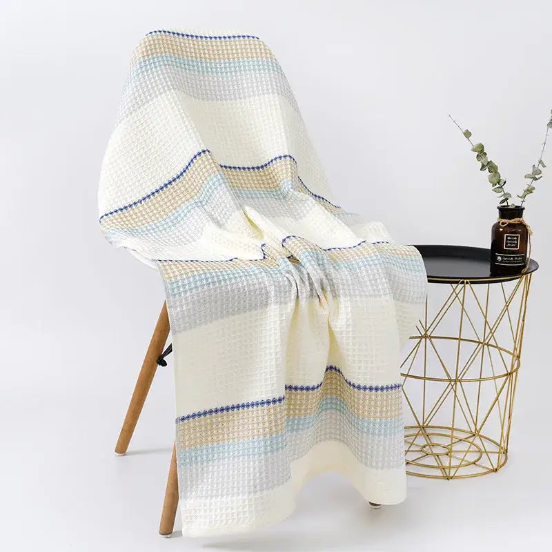 Embroidered white and blue cotton bath towel with honeycomb linen texture and waffle-weave throw blanket design