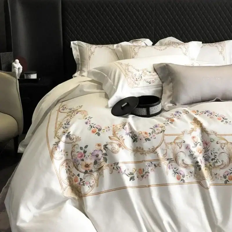 Cream-colored satin duvet cover with floral embroidery in pink, purple, and gold in egyptian cotton bedding set