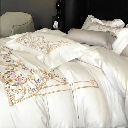 Embroidered white Egyptian cotton bedding set with floral embroidery in pastel hues and gold thread accents on satin duvet cover