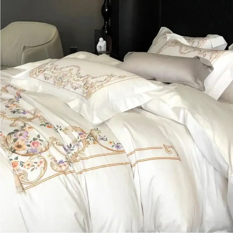 Embroidered white Egyptian cotton bedding set with floral embroidery in pastel hues and gold thread accents on satin duvet cover