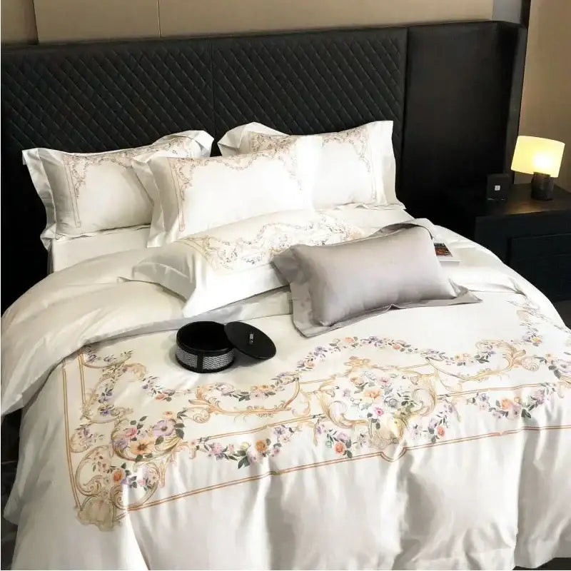 Luxurious white embroidered egyptian cotton bedding set with gold and pastel floral satin duvet cover border