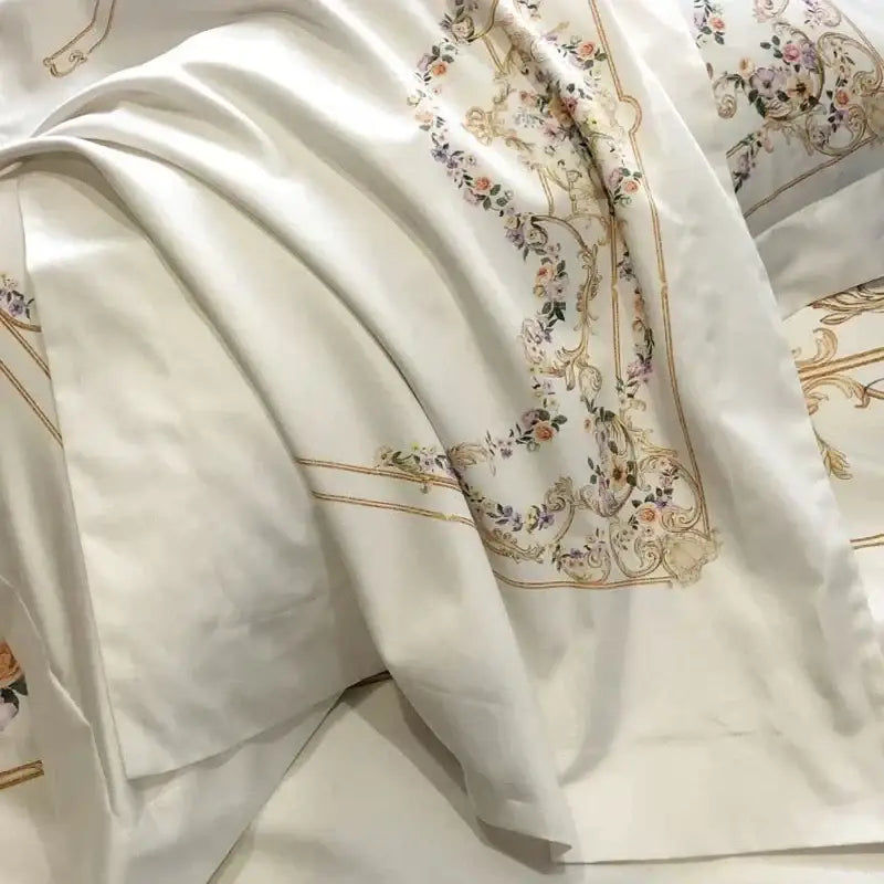 White satin egyptian cotton bedding set with delicate floral embroidery and gold-toned ornate borders for bedroom use
