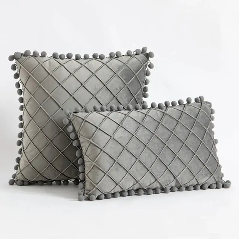 Gray velvet throw pillows with diamond-quilted pattern and pom-pom trim complement decorbites corduroy striped pompom pillowcase