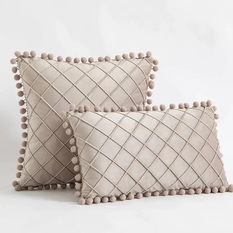 Beige velvet throw pillows with diamond-quilted pattern and fluffy pom-pom trim for decorbites corduroy striped pillowcase