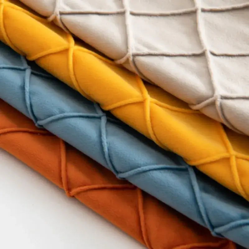Stacked quilted fabric in vibrant yellow soft blue and warm orange with a diamond pattern for decorbites corduroy striped pompom pillowcase