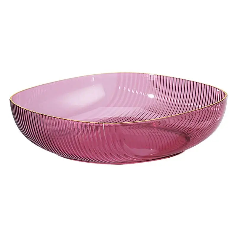 A translucent pink decorbites crystal fruit plate with vertical ridges and a gold rim for elegant dining decor