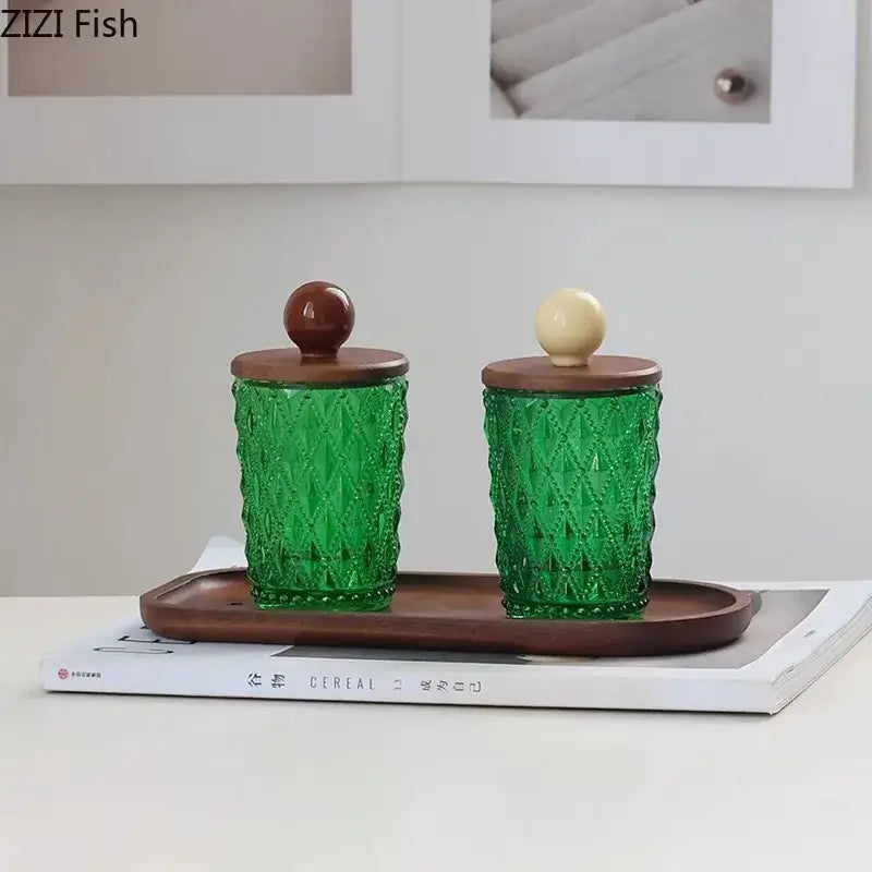Set of two emerald green textured glass storage jars with walnut lids and decorbites ceramic ball knobs for kitchen decor