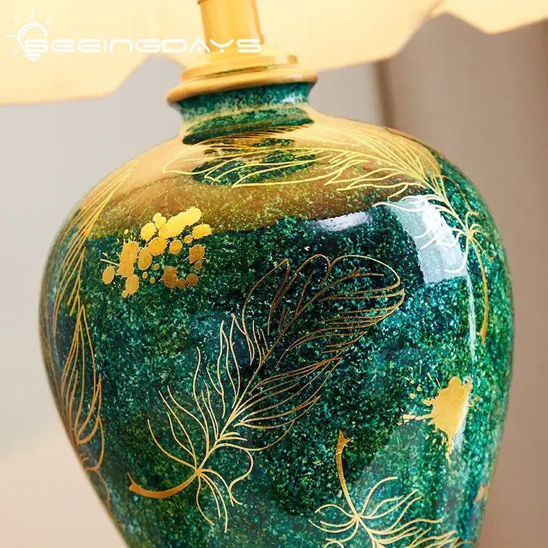 Emerald green ceramic table lamp with decorbites golden leaf floral patterns perfect for living room decor