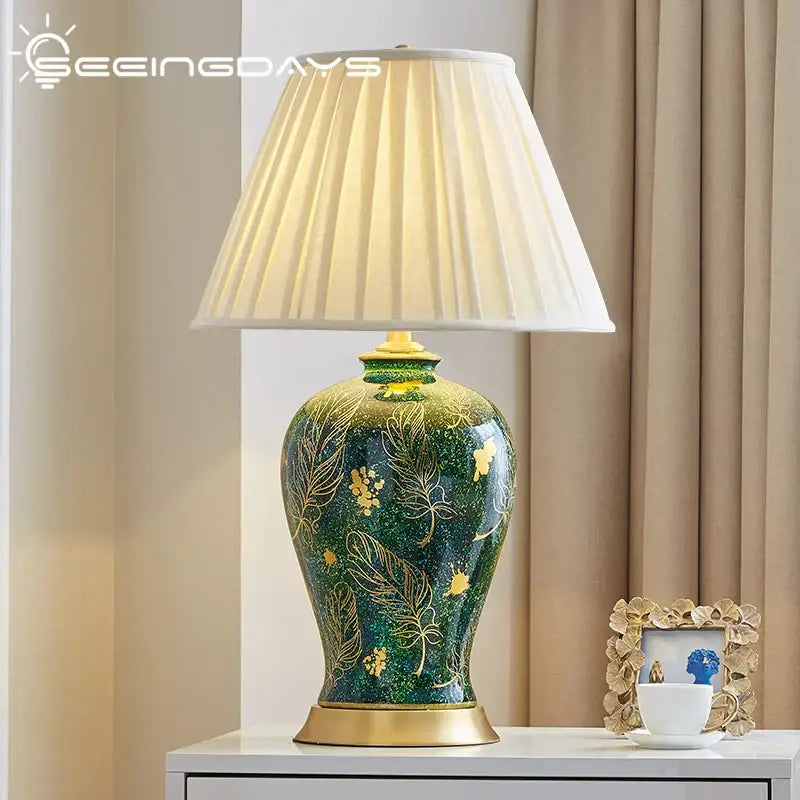 Emerald green floral ceramic table lamp with decorbites golden leaf patterns and cream pleated shade for living room decor
