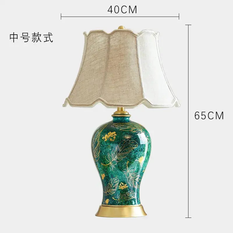 Emerald green floral ceramic table lamp with decorbites golden leaf patterns and beige fabric shade for living room decor