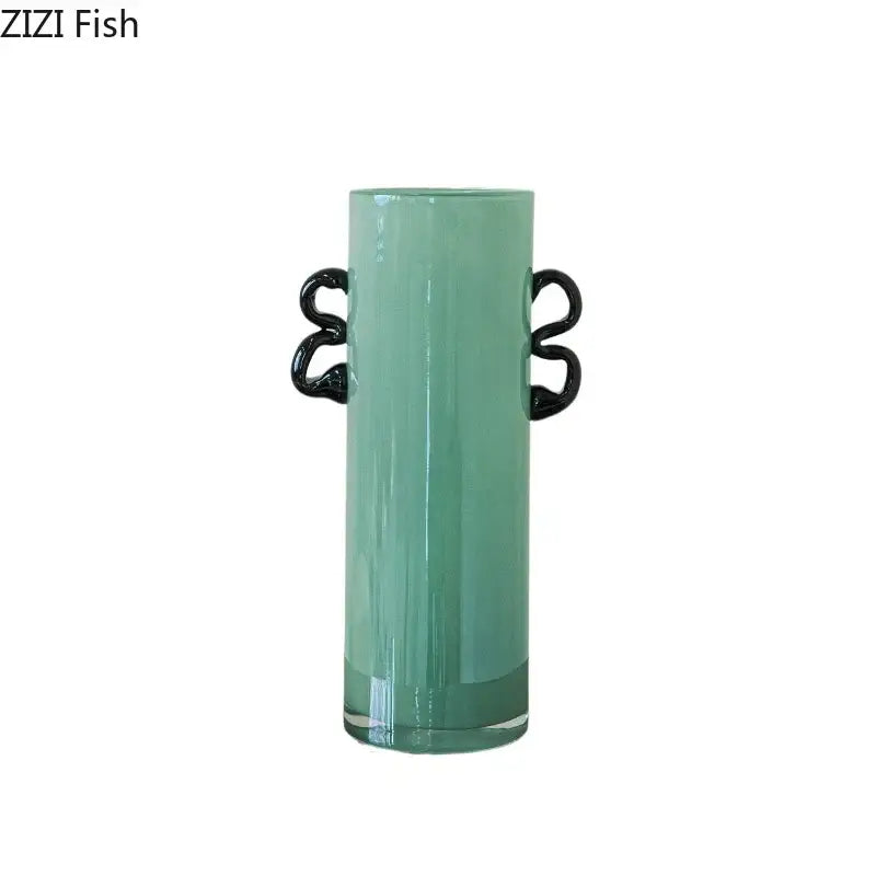 Emerald green glass vase with translucent mint-green body and sleek black serpentine handles for living room decor