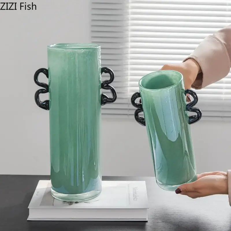 Emerald green glass vase with sleek translucent mint-green body and glossy black twisted handles for living room decor