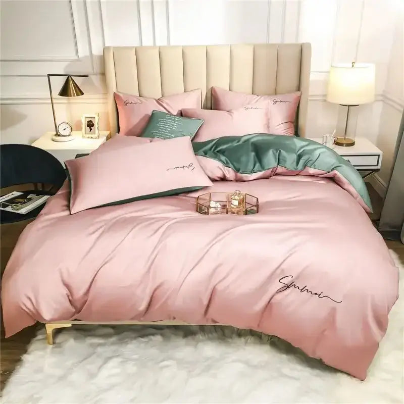 Emerald green and pink egyptian cotton bedding set featuring a pink satin duvet cover with embroidered design and matching pillows