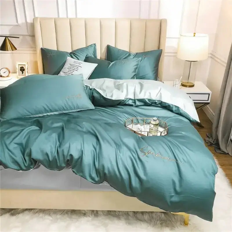 Teal satin duvet cover set with matching pillowcases and subtle gold embroidery in egyptian cotton bedding set