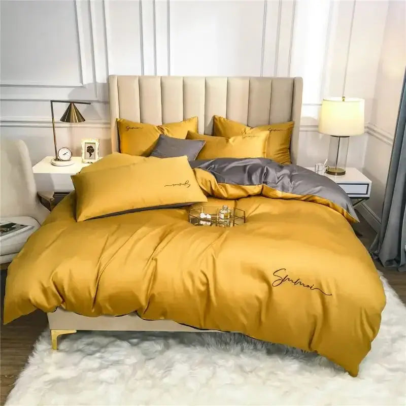Emerald green and pink egyptian cotton bedding set featuring golden satin duvet cover with embroidered script and gray accent pillows