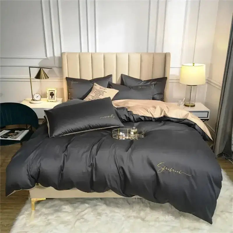Dark gray satin duvet cover set with gold cursive embroidery paired with emerald green and pink egyptian cotton bedding set