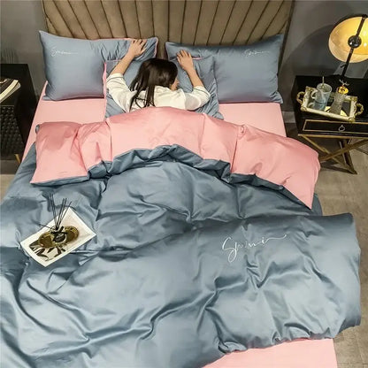 Emerald green and pink egyptian cotton bedding set featuring pink and blue satin duvet with embroidered script detailing