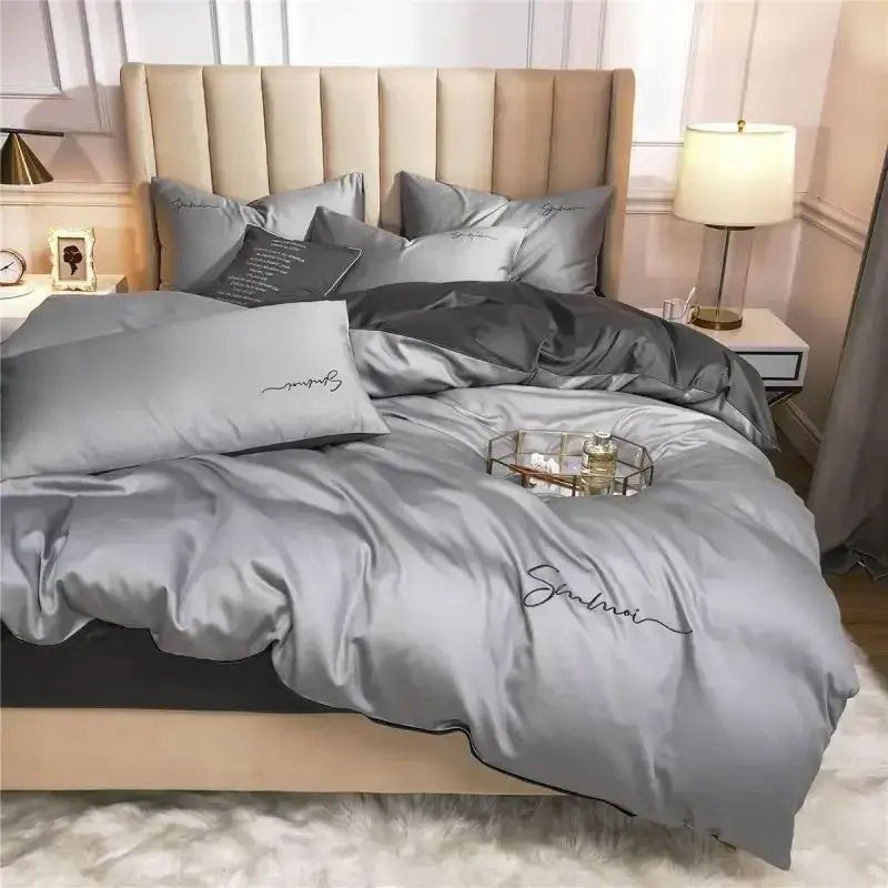 Gray satin duvet cover set with black trim and embroidered cursive script complements emerald green pink egyptian cotton bedding set