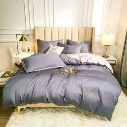 Luxurious gray satin duvet cover with subtle gold embroidery in an emerald green and pink egyptian cotton bedding set