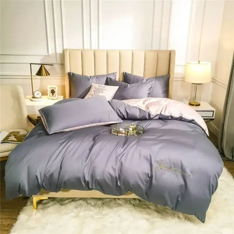 Luxurious gray satin duvet cover with subtle gold embroidery in an emerald green and pink egyptian cotton bedding set