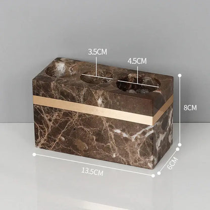 Brown emperador dark marble toothbrush holder with gold trim featuring three circular slots for bathroom use