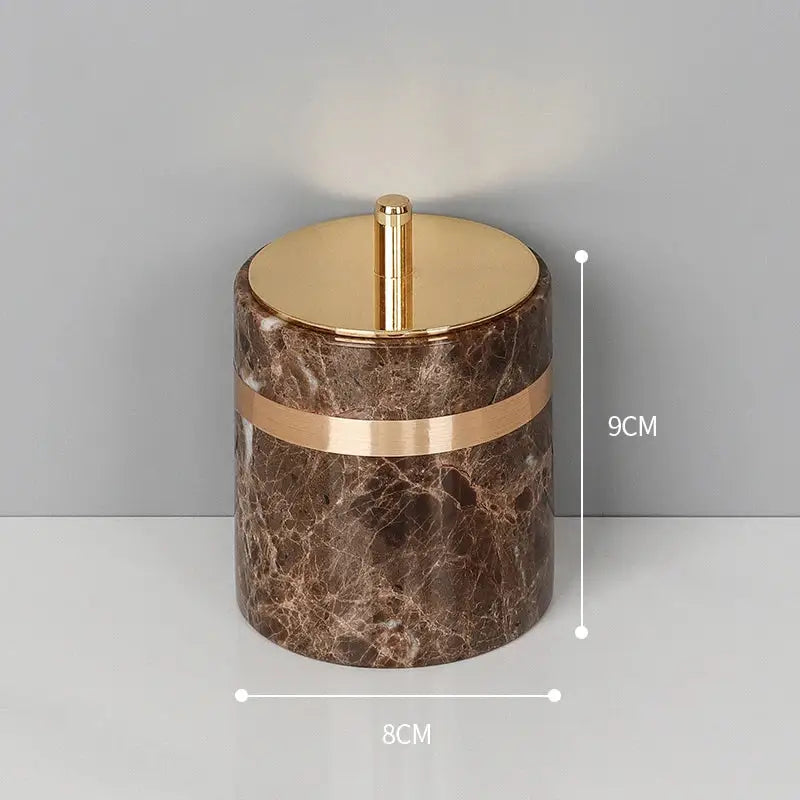 Brown emperador dark marble cylindrical container with gold-toned lid and accent band for dark marble bathroom use