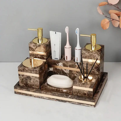 Brown emperador dark marble bathroom organizer with gold accents and compartments for soap toothbrush lotion and diffuser sticks