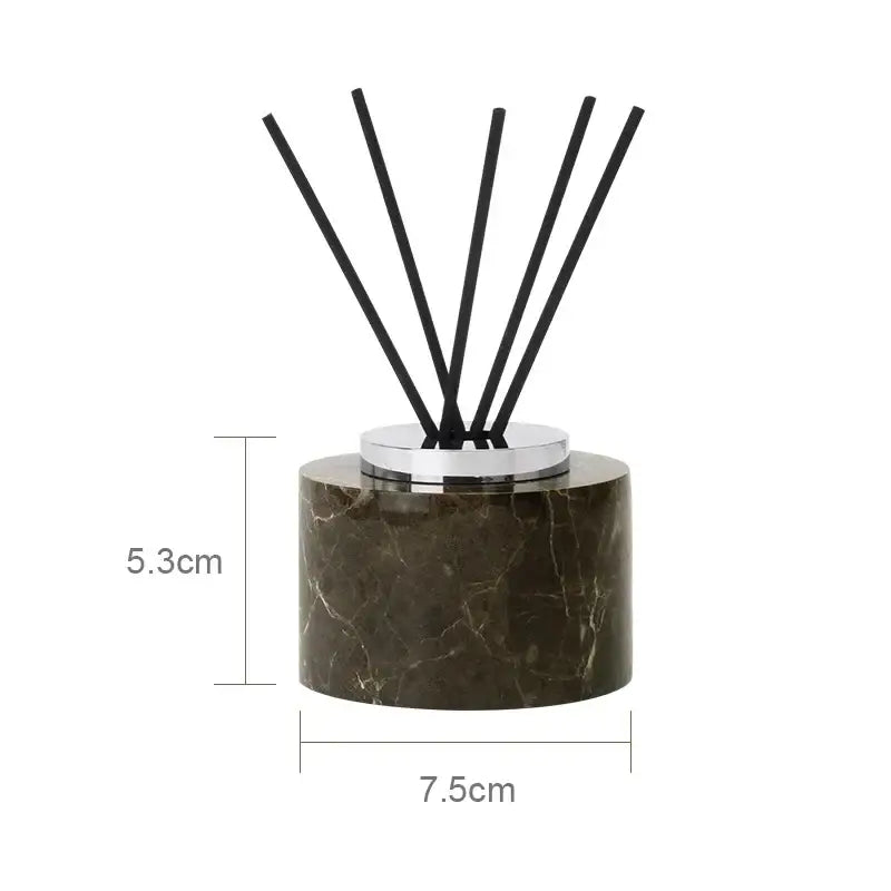 Dark brown emperador dark marble diffuser with chrome metal top and five black reed sticks for dark marble bathroom use