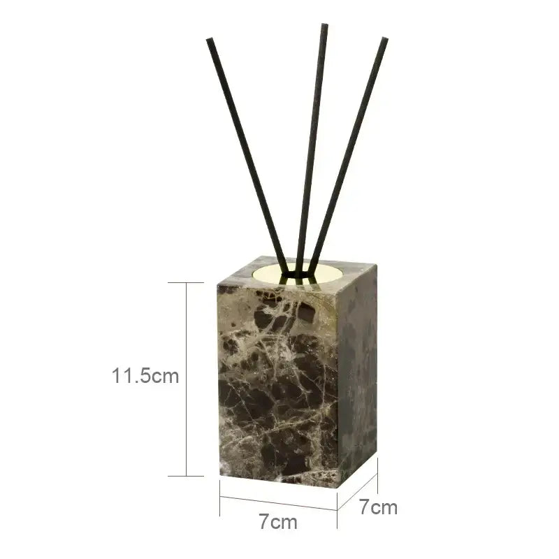 A sleek dark brown emperador dark marble reed diffuser with a square base and four black reeds for bathroom use