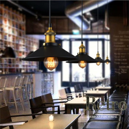 Black and gold industrial pendant light with a vintage edison bulb design.