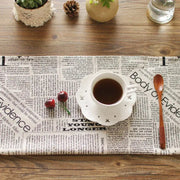 White ceramic coffee cup with perforated patterns and crosses on matching saucer for english newspaper style photography props
