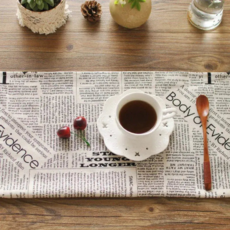 White ceramic coffee cup with perforated patterns and crosses on matching saucer for english newspaper style photography props