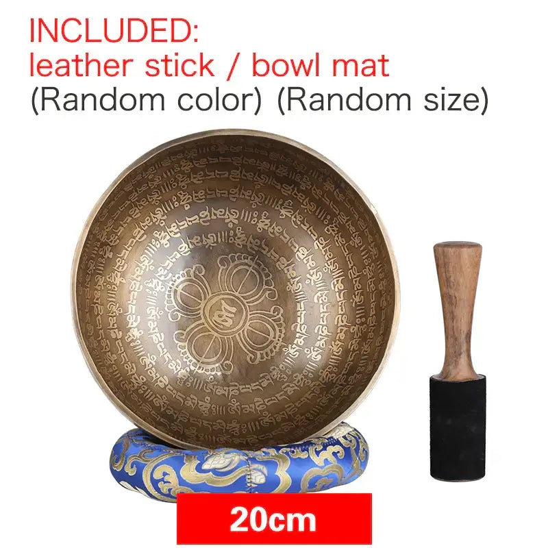 A 20cm bronze engraved gold tibetan singing bowl with sanskrit script on a blue and gold cushion for yoga meditation