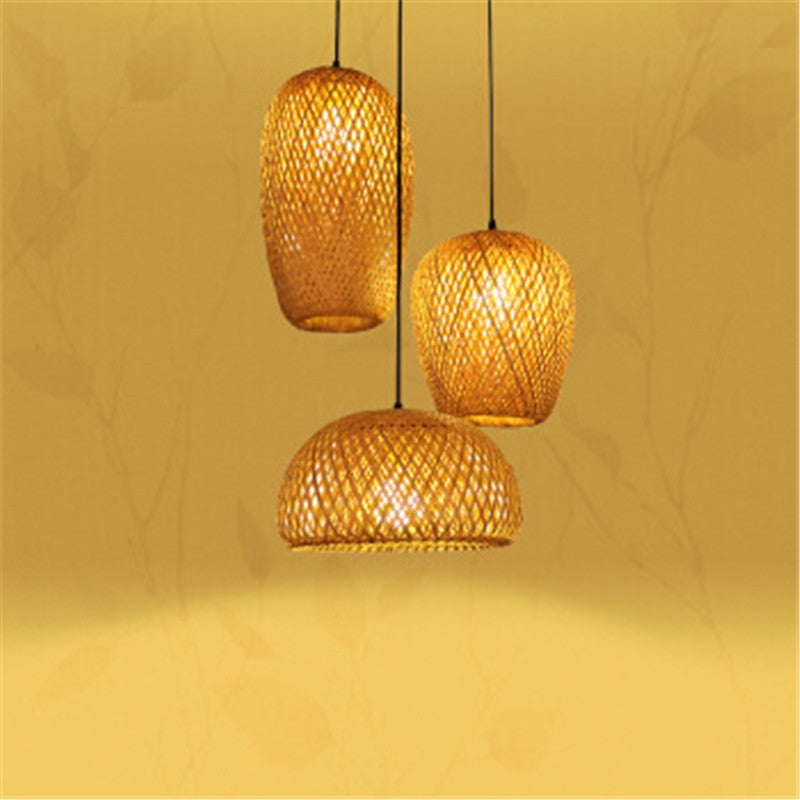Rattan pendant light with woven design and warm yellow glow.