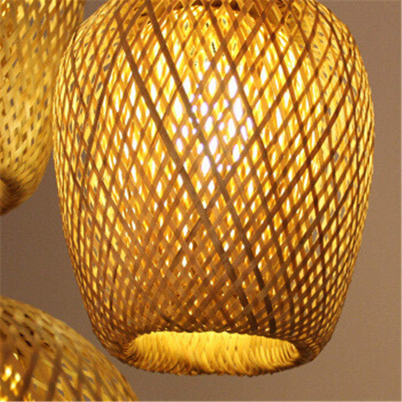 Entrance three head lights featuring bamboo pendant light with woven texture and warm glow as light sources