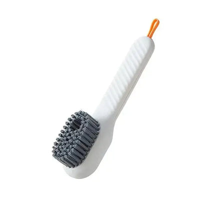 Ergonomic white plastic electric cleaning brush with gray bristles and orange loop handle for kitchen and bathroom use