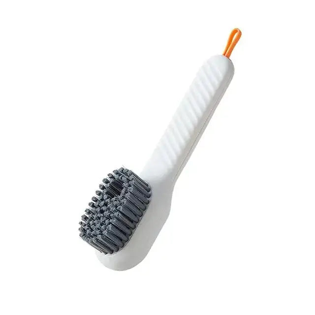 Ergonomic white plastic electric cleaning brush with gray bristles and orange loop handle for kitchen and bathroom use