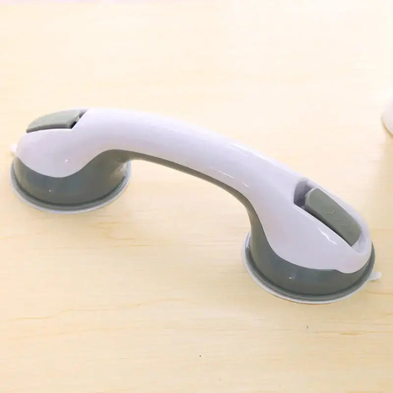 Ergonomic white and gray plastic bathroom safety handle with suction cups for secure attachment and support