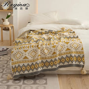 Cozy cream-colored ethnic bohemian blanket knit with geometric mustard and black patterns tassels for living room decorbites ethnic decor