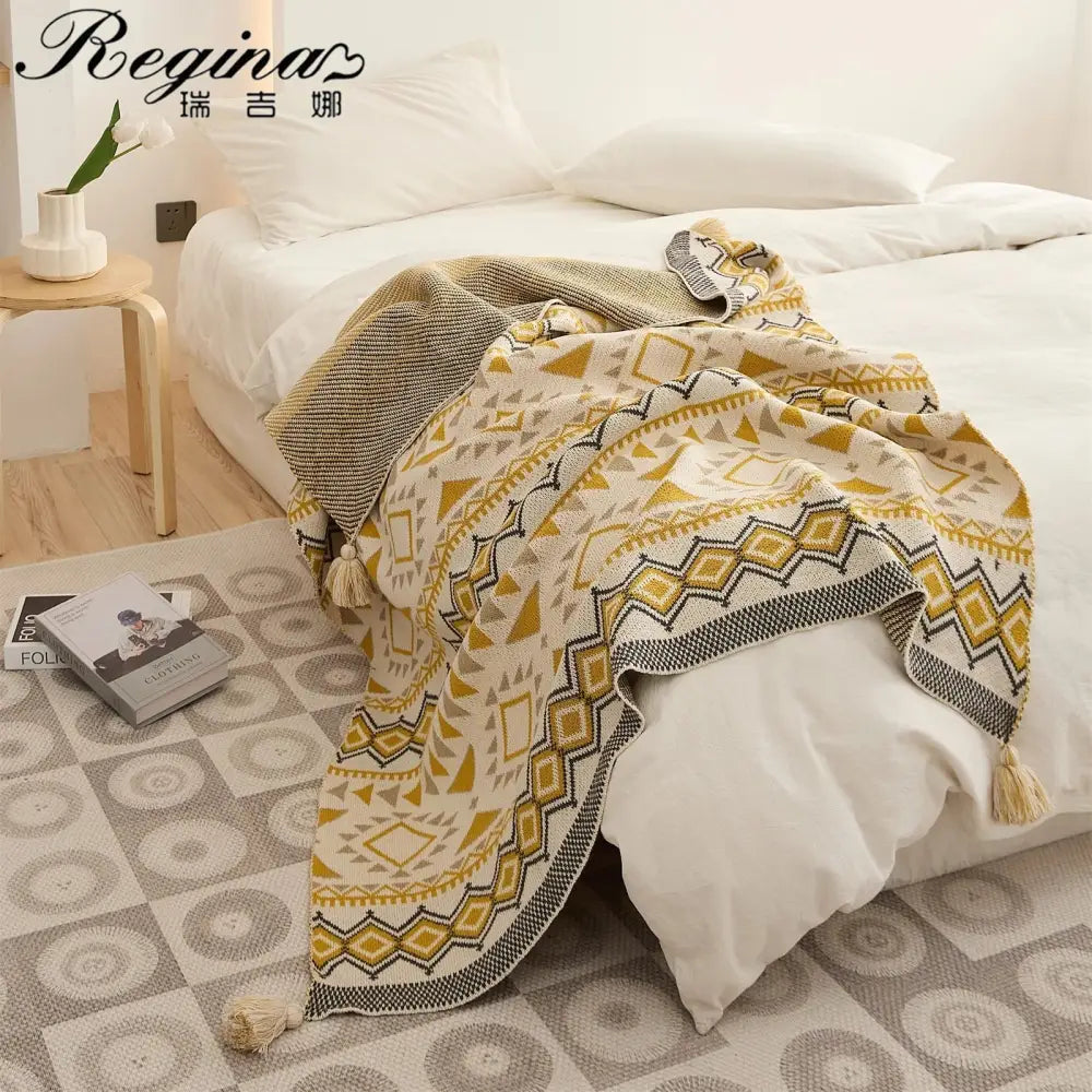 A decorbites ethnic bohemian cream and mustard knit throw blanket with geometric patterns and tassels for living room decor