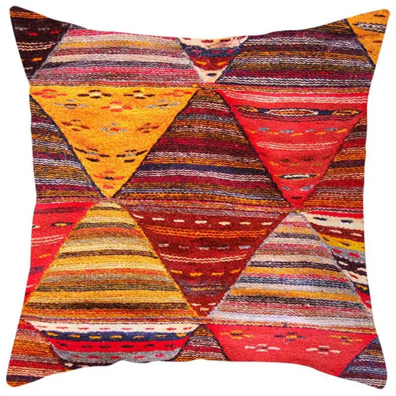 Vibrant ethnic bohemian geometric pillow cover with woven textile design in bold reds oranges and earthy tones for decorbites decor