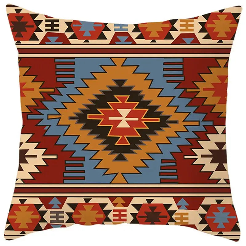 Square pillow cover with vibrant ethnic bohemian geometric southwest-style pattern in bold reds blues on textured fabric decorbites decor