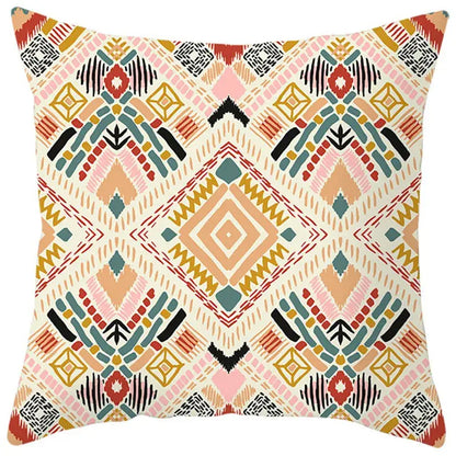 A square throw pillow cover with a vibrant ethnic bohemian geometric pattern in pink orange teal black and cream decorbites