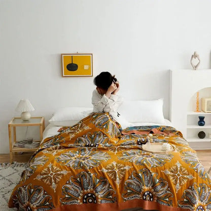 A vibrant mustard-yellow decorbites ethnic cotton blanket with brown cream and teal paisley floral patterns for bedroom decor