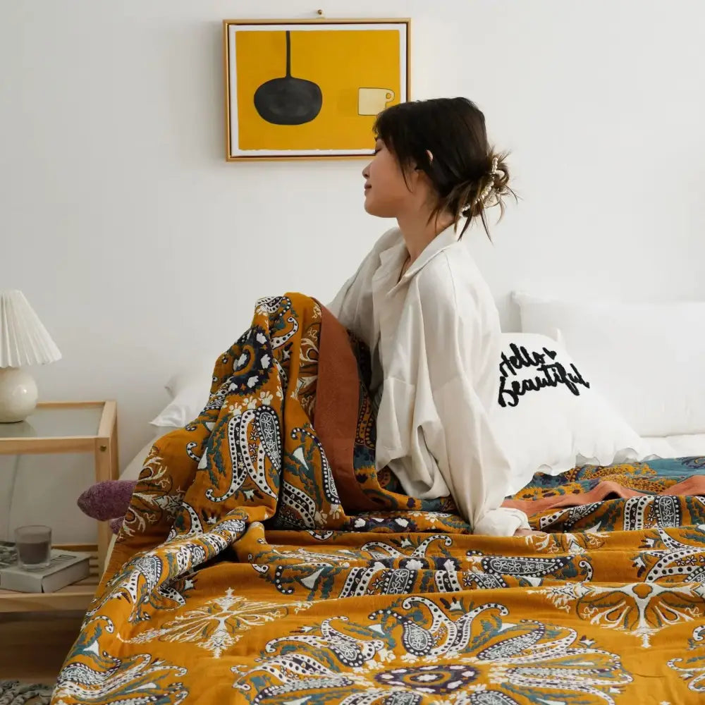 Cozy mustard-yellow decorbites ethnic cotton blanket with intricate navy white and brown paisley patterns for bedroom decor