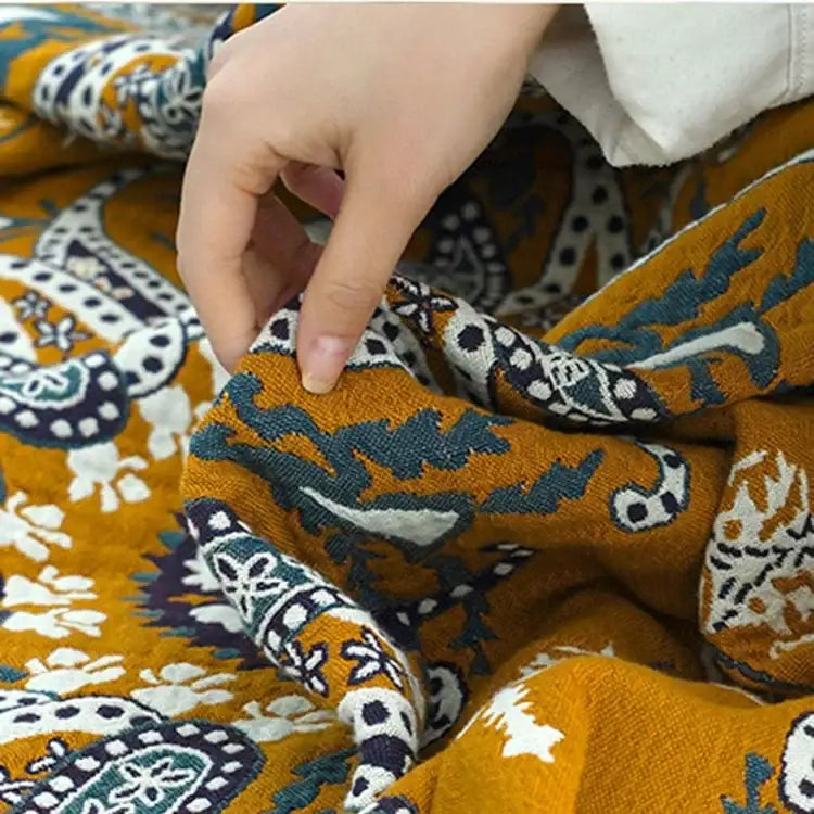Ethnic cotton blanket by decorbites featuring mustard yellow fabric with navy paisley and floral patterns for bedroom decor