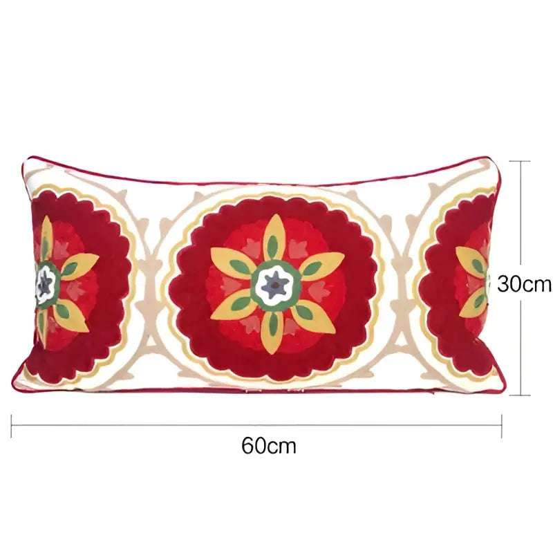 Rectangular pillow cover with embroidered floral red and cream ethnic tassels featuring a starburst design and scalloped edges
