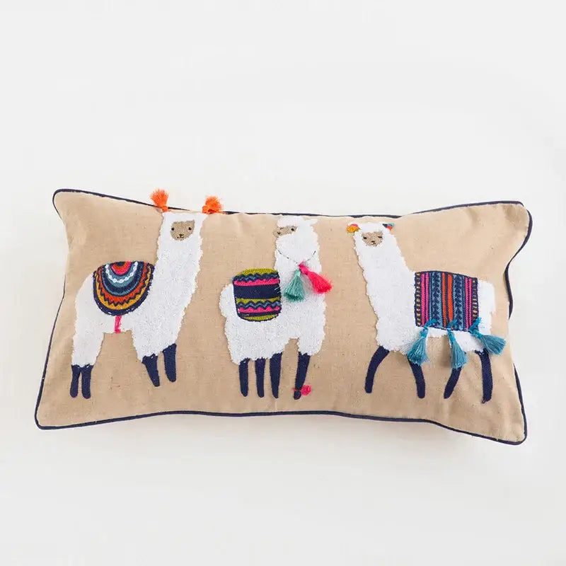 Beige rectangular pillow cover with ethnic tassels featuring embroidered floral alpacas for living room decor
